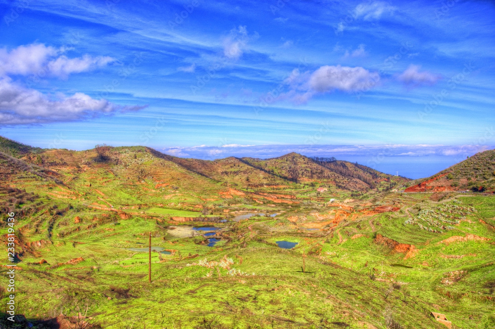 North-west coast of Tenerife mountains and green grass with blue sky with clouds, Canarian Islands
