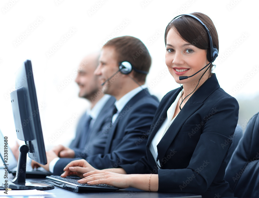 Female Customer Services Agent With Headset Working In A Call Center Female Customer Services Agent With Headset Working In A Call Center