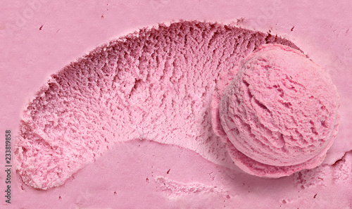 Strawberry  ice cream scoop on spooned ice cream background  