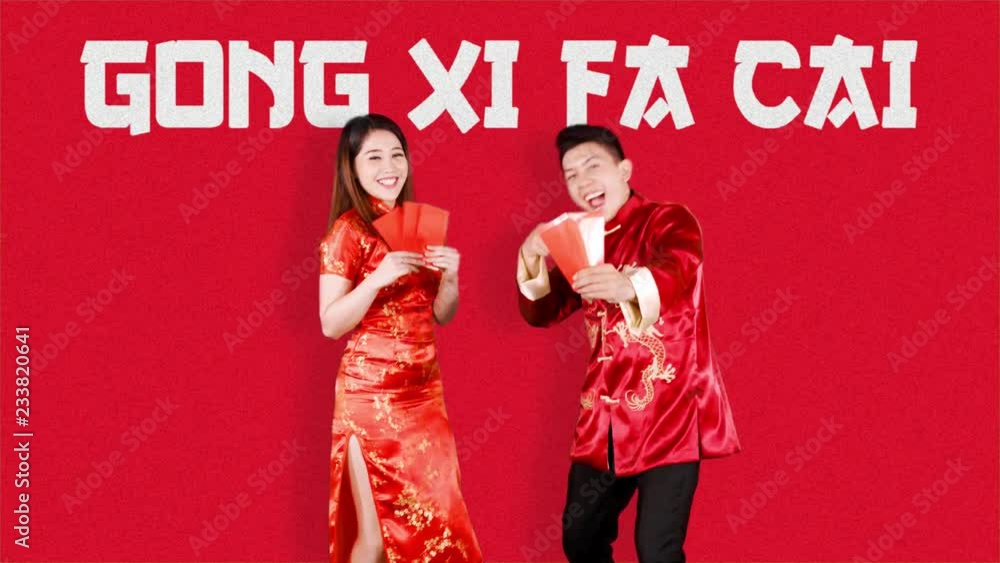 Cheerful Asian couple holding red envelope on Chinese New Year or Gong Xi Fa Cai day celebration. Shot in 4k resolution with red background Cheerful Asian couple holding red envelope on Chinese New Year or Gong Xi Fa Cai day celebration. Shot in 4k resolution with red background