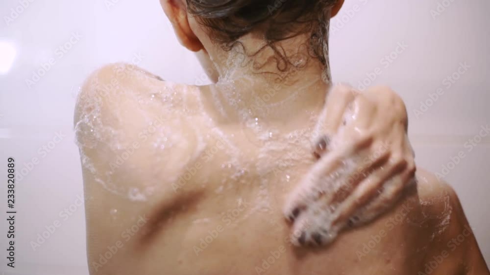 beautiful young red-haired woman bathes in the shower, washes her hair and her body beautiful young red-haired woman bathes in the shower, washes her hair and her body