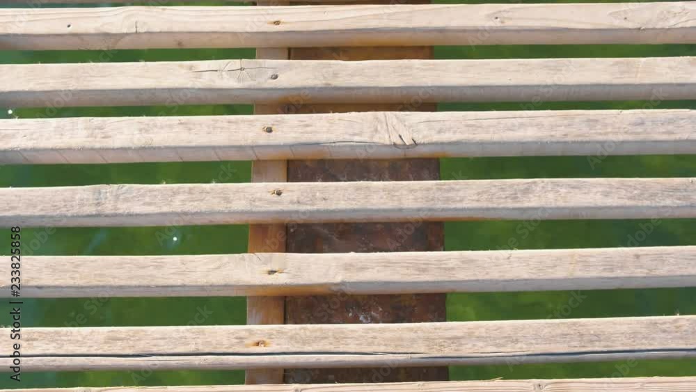 Wooden pier in the sea close-up with clear blue water under it. Wooden pier in the sea close-up with clear blue water under it.
