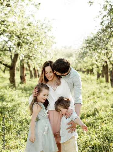 beautiful family in the apple orchard © bulashenko