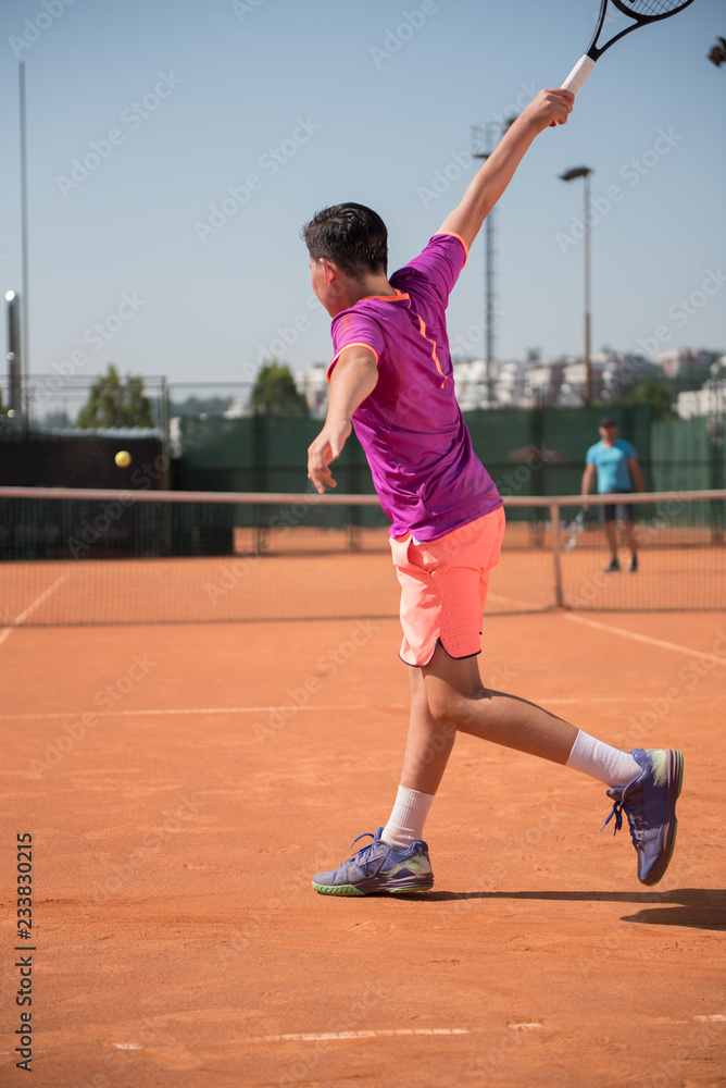 Young tennis player playing backhand