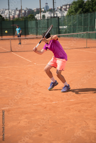Young tennis player playing backhand © cirkoglu