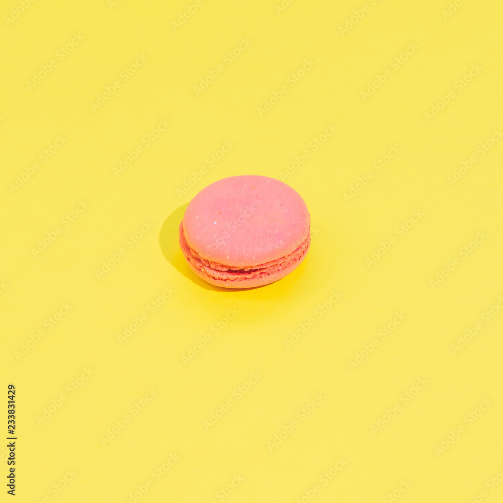 Cake macaron or macaroon on yellow background from above, colorful almond cookies, minimalism, sharp shadow Cake macaron or macaroon on yellow background from above, colorful almond cookies, minimalism, sharp shadow