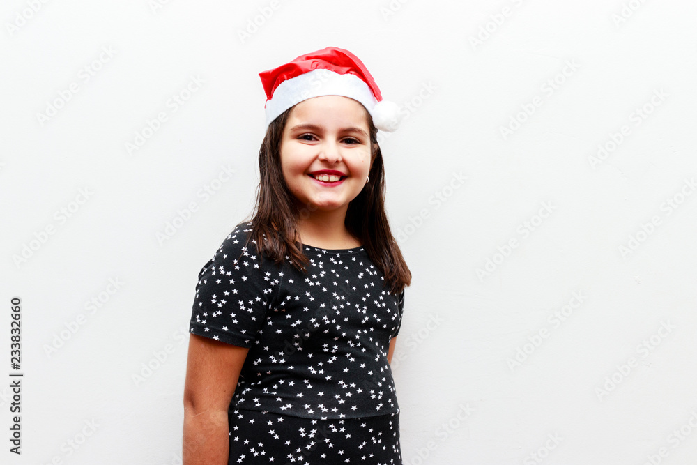 portrait of caucasian toddler girl with christmas hat, white background portrait of caucasian toddler girl with christmas hat, white background