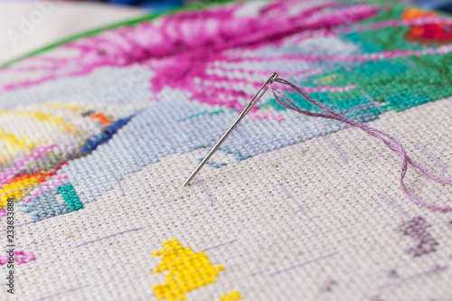 The process of working on a piece of embroidery.