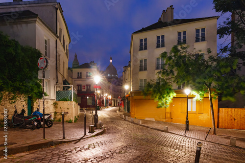 Fototapeta Naklejka Na Ścianę i Meble -  Empty street and the Sacre-Coeur at night, quarter Montmartre in Paris, France