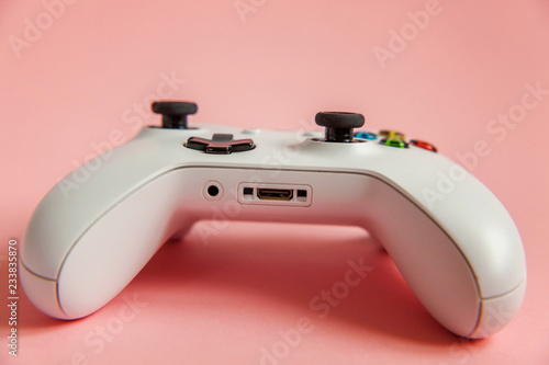 White joystick gamepad, game console on pink colourful trendy modern fashion pin-up background. Computer gaming competition videogame control confrontation concept. Cyberspace symbol