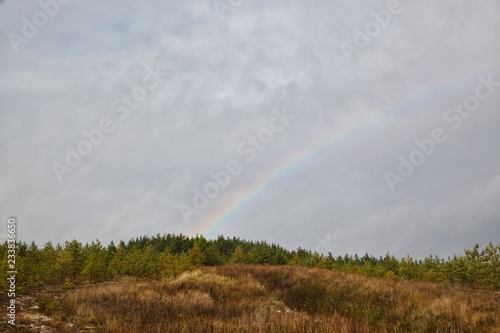 View of the surrounding hills and meadows in autumn, rainbow. © ALEKSANDR
