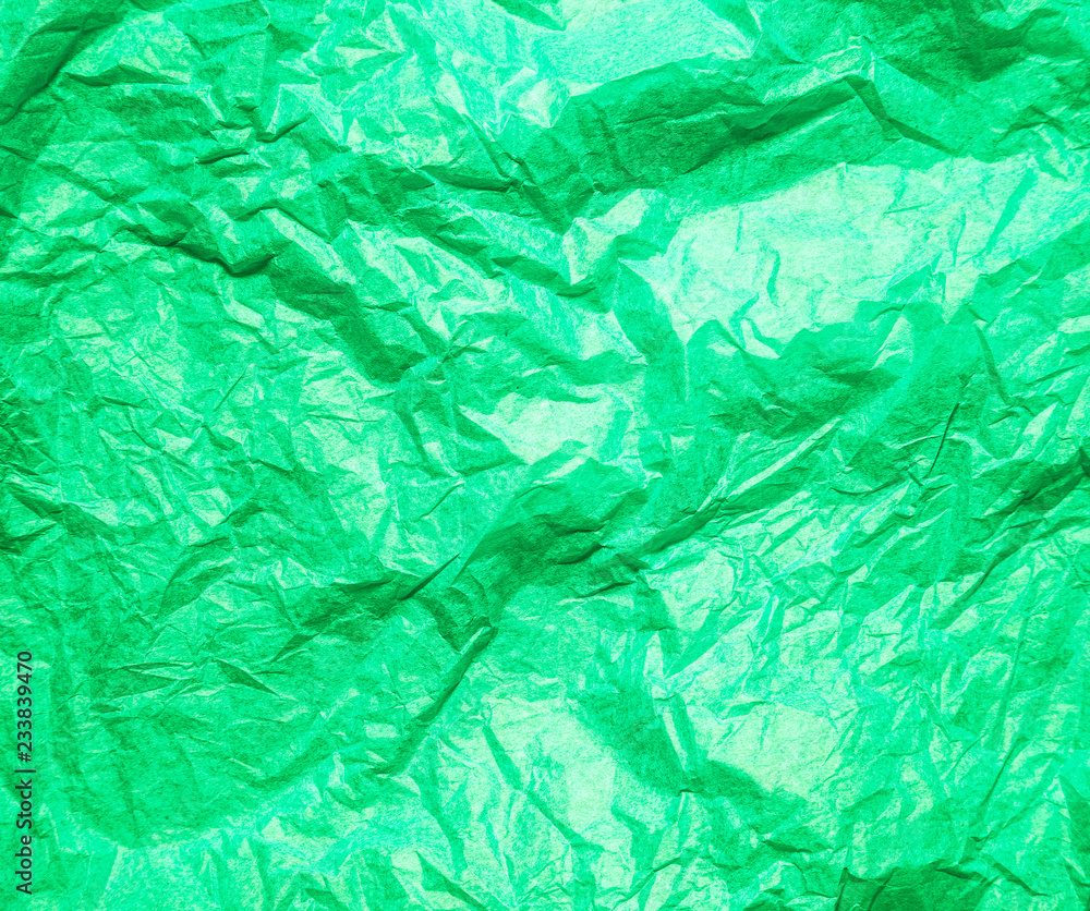 Fototapeta premium Green crumpled paper abstract background