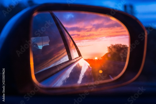 Fiery sunset as seen on the car's side mirror