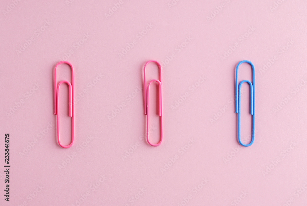 Colored paper clips on a pink background. Colored paper clips on a pink background.