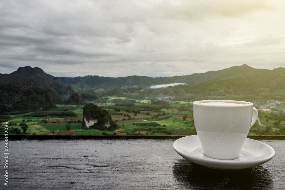 coffee cup on table with Mountain views in the morning as a background coffee cup on table with Mountain views in the morning as a background