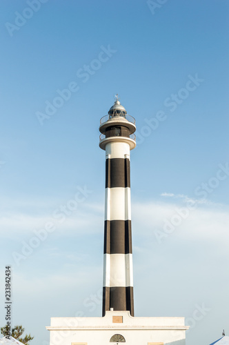 View of the lighthouse of Menorca Cap d Artrutx, with a blue sky in the background. Balearic Islands, Mediterranean Sea.