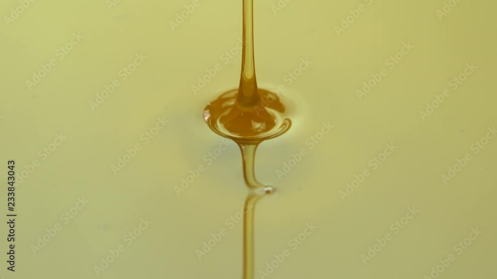 Pouring honey. Macro shot of honey dripping
Pouring honey. Macro shot of honey dripping