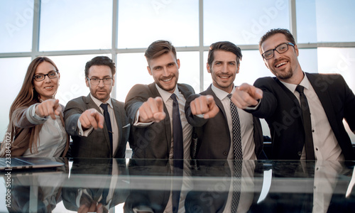 Businessmen in their office pointing to the front