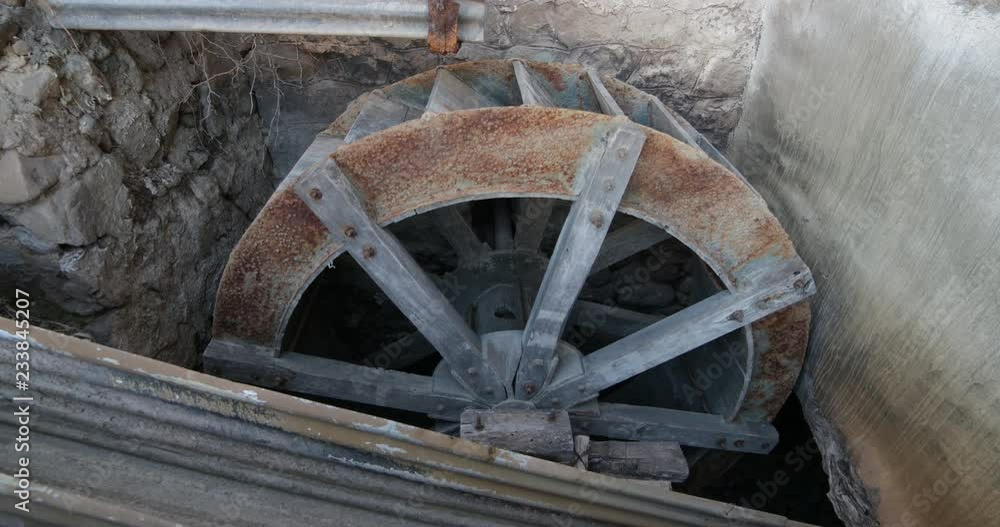 Detail of old abandoned water wheel of flour watermill. Wood structure for grinding wheat grains. Detail of old abandoned water wheel of flour watermill. Wood structure for grinding wheat grains.