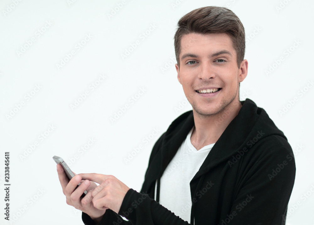 successful young man typing SMS on smartphone successful young man typing SMS on smartphone
