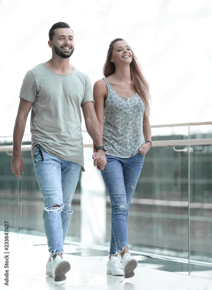 Young couple walking together hand by hand