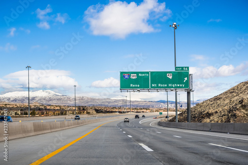 Travelling on the interstate towards Reno; the city's downtown visible in the background; Nevada