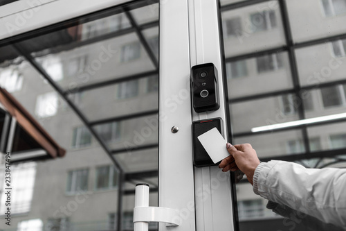 Security technologies, security systems, electronic keys, motion sensors. Hands open the door