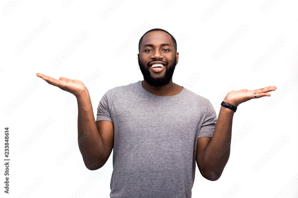 A happy blogger talks about his field by comparing its different components. On a white studio background. Freestyle on an isolated background. Comparison, weighting, choice between two components A happy blogger talks about his field by comparing its different components. On a white studio background. Freestyle on an isolated background. Comparison, weighting, choice between two components