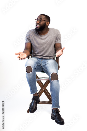 Young confident successful businessman conducts training for start-ups, trains, conducts lectures in front of a large audience, writes online courses in the studio on a white background. Leader