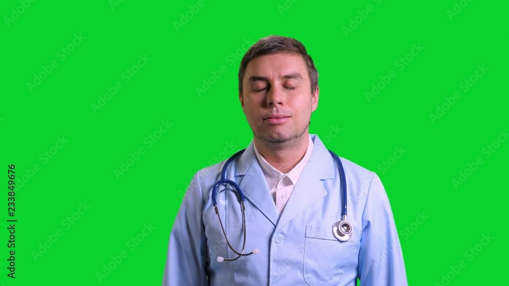 Young doctor stand and smile on green chroma key background Young doctor stand and smile on green chroma key background
