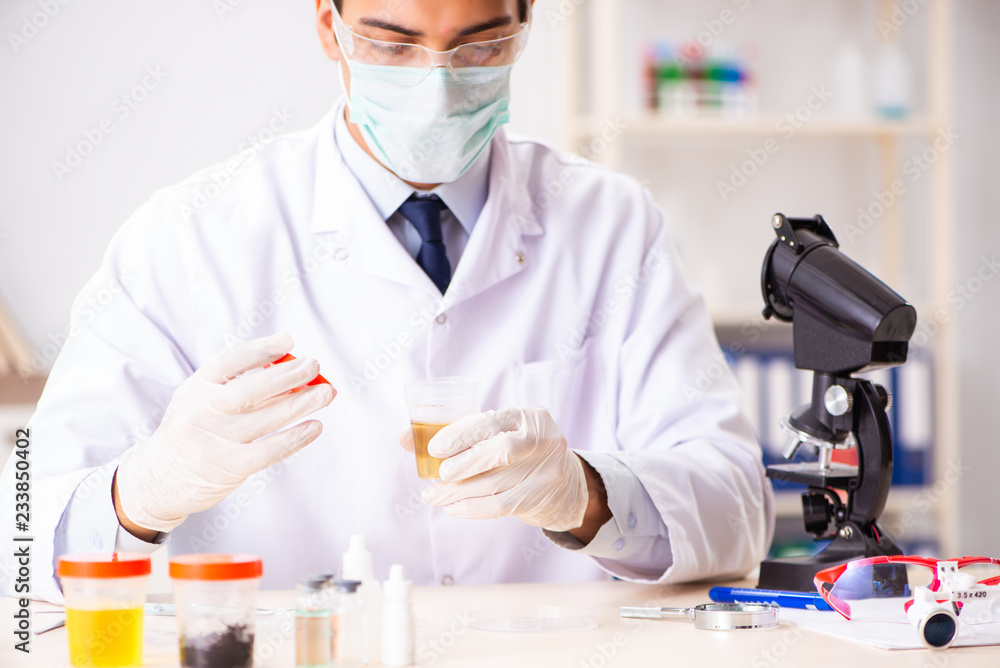 Young handsome chemist working in the lab Young handsome chemist working in the lab