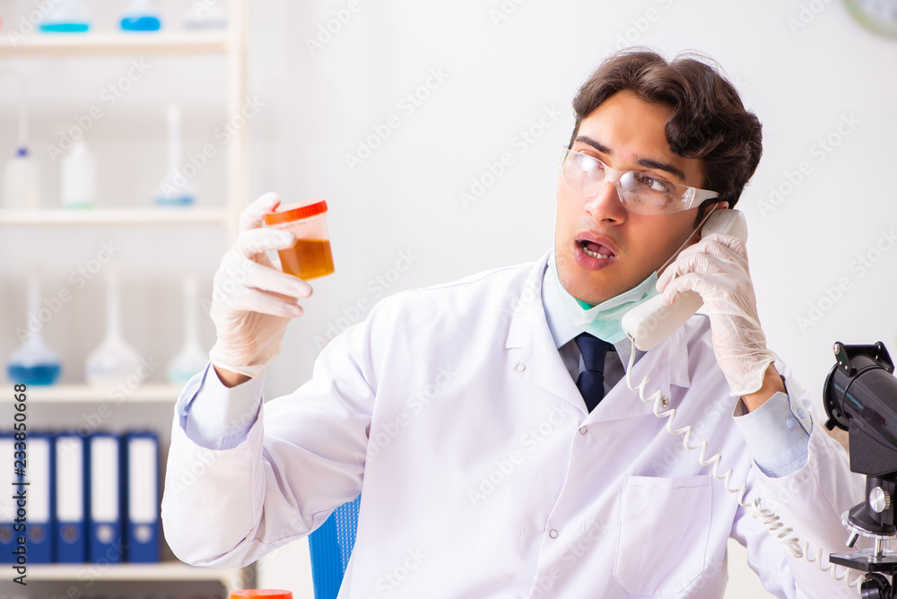 Young handsome chemist working in the lab Young handsome chemist working in the lab