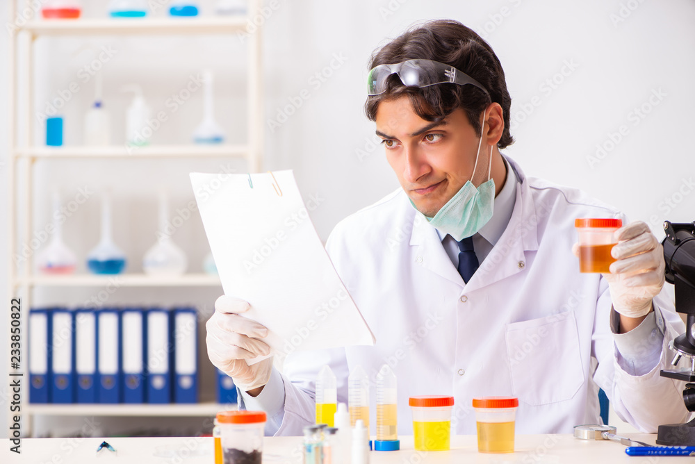 Young handsome chemist working in the lab Young handsome chemist working in the lab