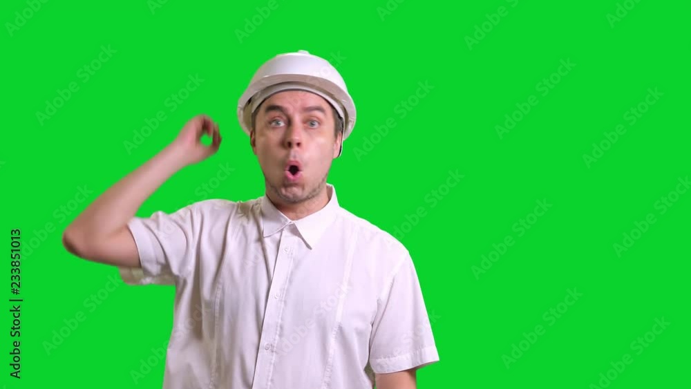 Young male engineer in white hardhat and shirt have new idea on green screen background Young male engineer in white hardhat and shirt have new idea on green screen background
