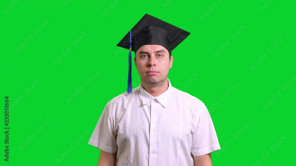 Young male smiling graduate college in black hat doing thumbs up on chroma key background