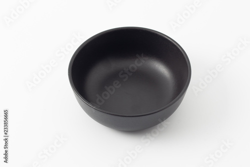 Black empty ceramic bowl isolated on white background.