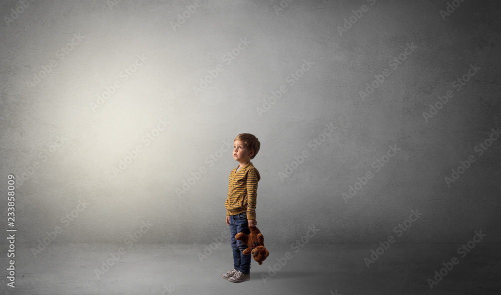 Little waggish kid staying alone in a big empty room with his plush
Little waggish kid staying alone in a big empty room with his plush