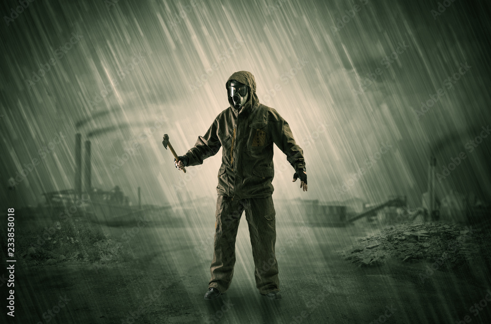 Gas masked survival man coming with arms on his hand in a demolished dark environment
Gas masked survival man coming with arms on his hand in a demolished dark environment