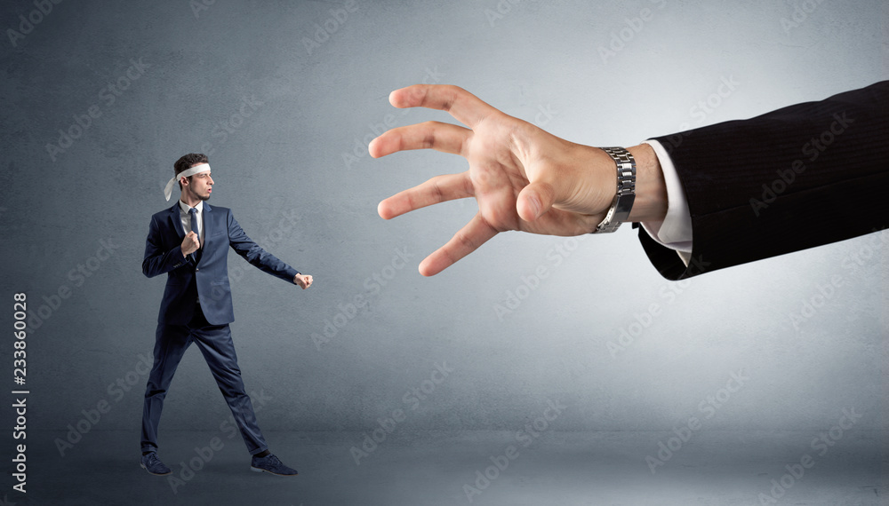Small karate man fighting with big hand Small karate man fighting with big hand