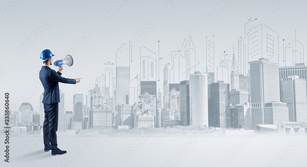 Young supervisor architect standing and replanning a big city panorama
Young supervisor architect standing and replanning a big city panorama
