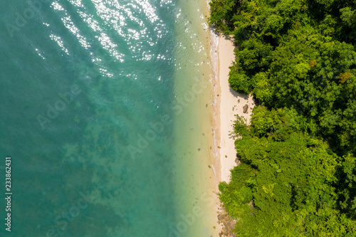 Aerial drone view of a beautiful tropical sandy beach surrounded by lush forest (Koh Yao Noi, Thailand)