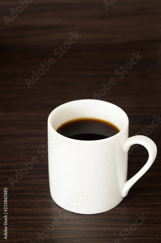 Cup of black coffee on wooden background. overhead shot