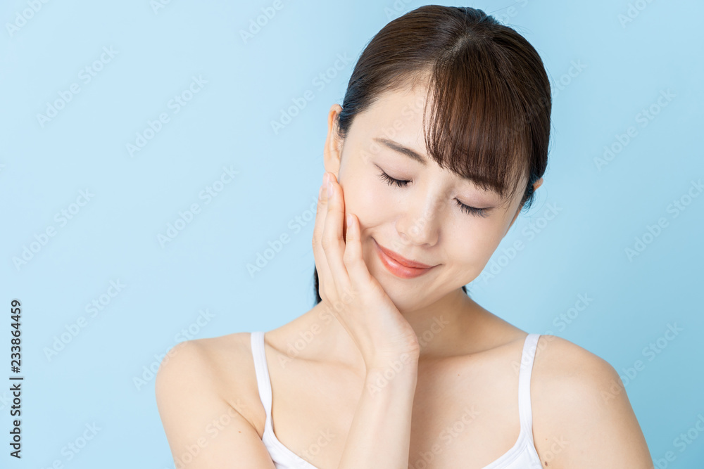 attractive asian woman beauty image on blue background attractive asian woman beauty image on blue background
