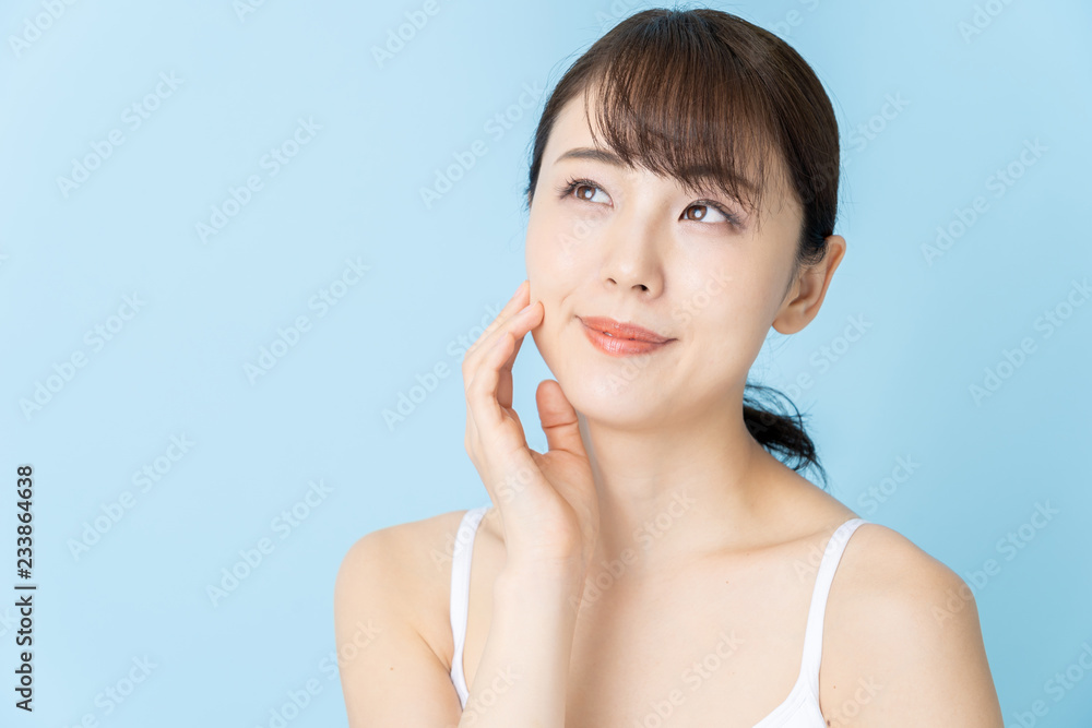 attractive asian woman beauty image on blue background attractive asian woman beauty image on blue background