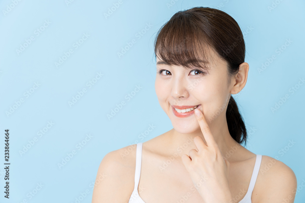 attractive asian woman beauty image on blue background attractive asian woman beauty image on blue background