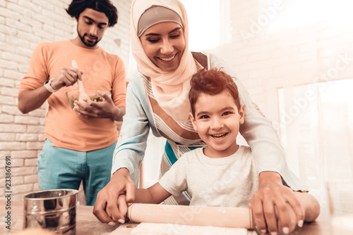 Принти на полотні Happy Arabian Family Cooking Food in Kitchen.