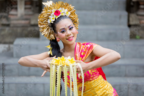 Female dancer doing Pendet dances in temple photo