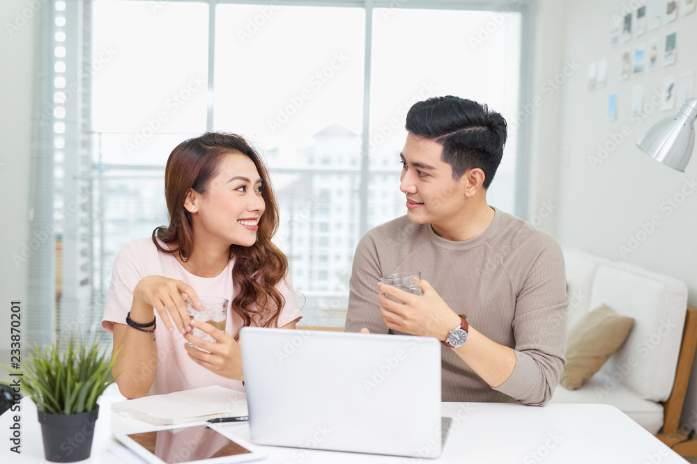 Businessman and businesswoman working with laptop at modern office Businessman and businesswoman working with laptop at modern office