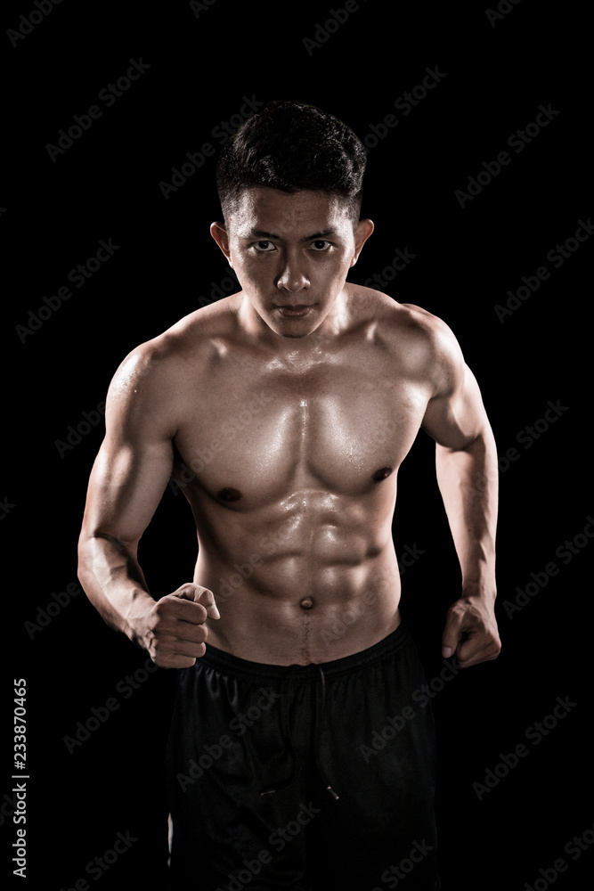 Muscular man running in dark background