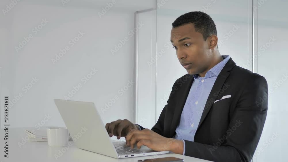 Shocked Casual Afro-American Businessman Working on Laptop, Astonished Shocked Casual Afro-American Businessman Working on Laptop, Astonished